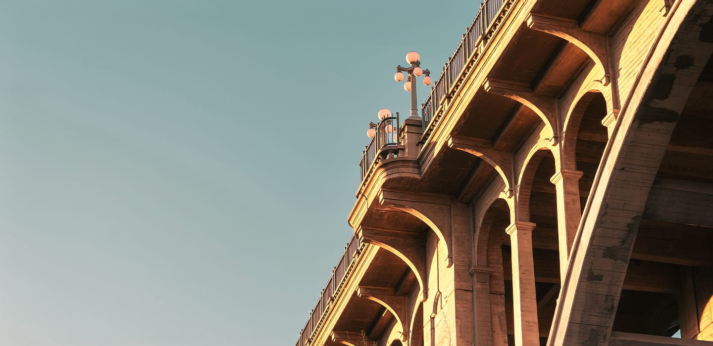 Sunlit Pasadena Bridge with detailed archways and lampposts